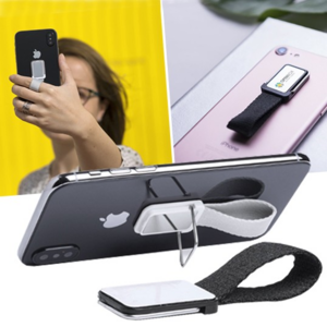 5999, Original soporte adhesivo para smartphone con cinta para selfies en resistente poliéster y pastilla central para marcaje. Con soporte metálico y presentado en atractiva bolsita de diseño. Adhesivo